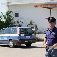 Des policiers devant le suspect de l'attentat de Brindisi